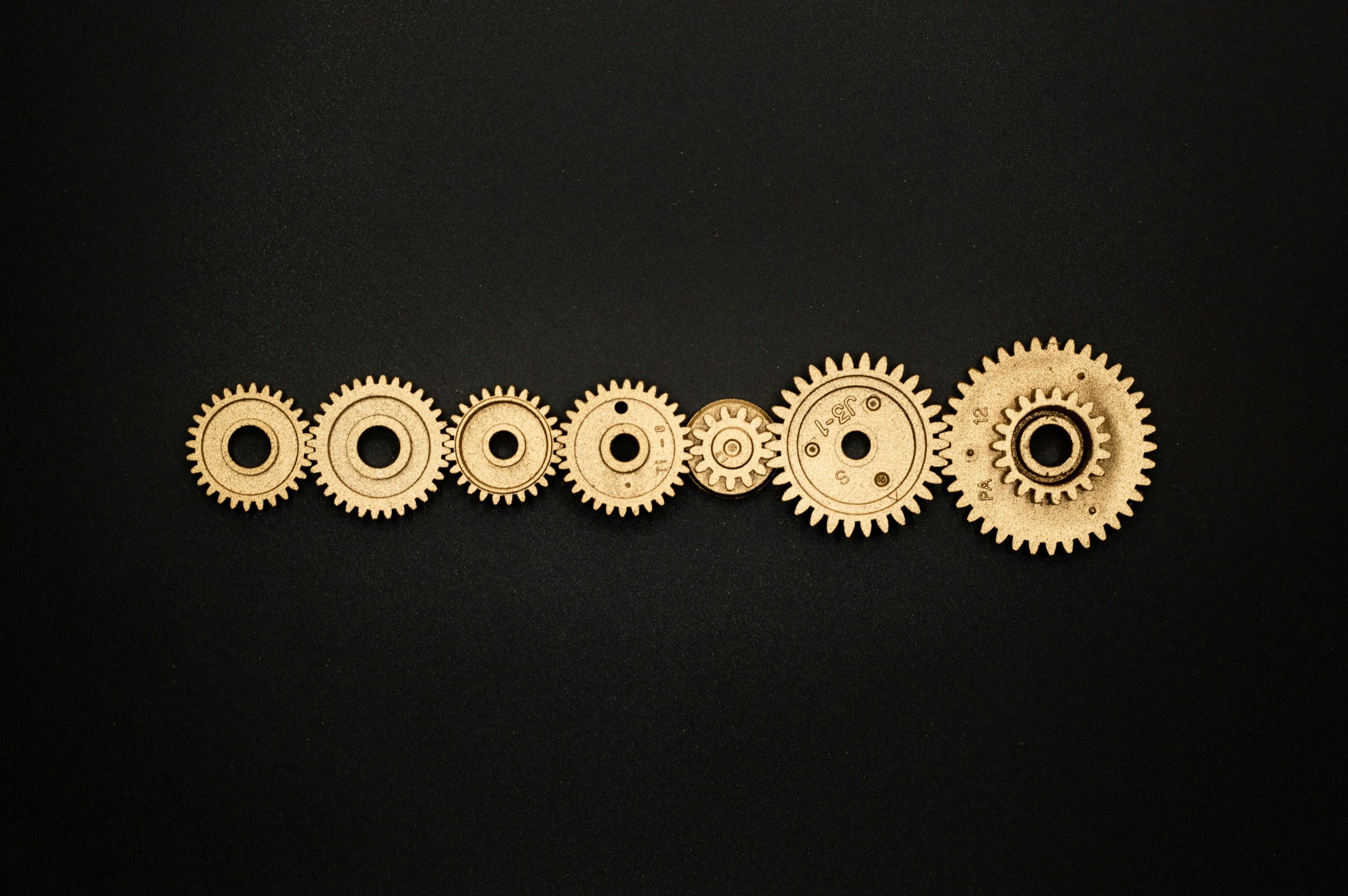 Interlocking gears representing the systems, resources, and partnerships that power a scalable business model.