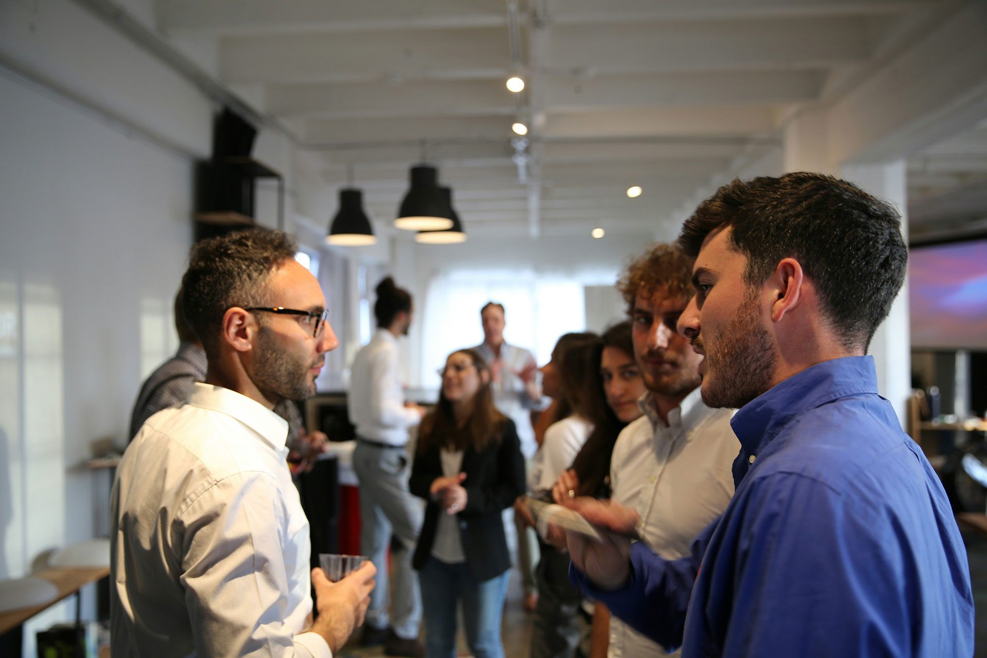 Building Business Growth Through Community Networks Group of professionals networking and having conversations at a business event, representing how strong communities create trust, collaboration, and long-term business value that compounds over time.