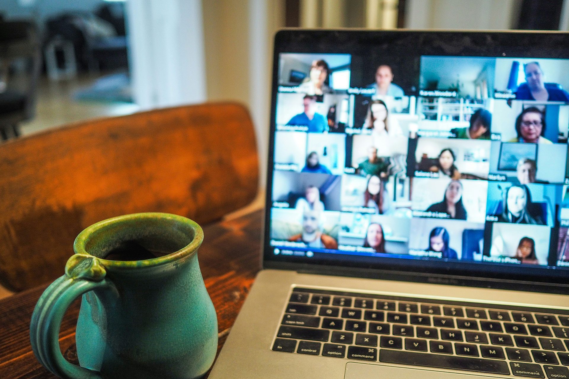 Laptop displaying a virtual team meeting with multiple participants, representing a business that operates through documented systems, shared knowledge, and team collaboration rather than relying solely on the founder.