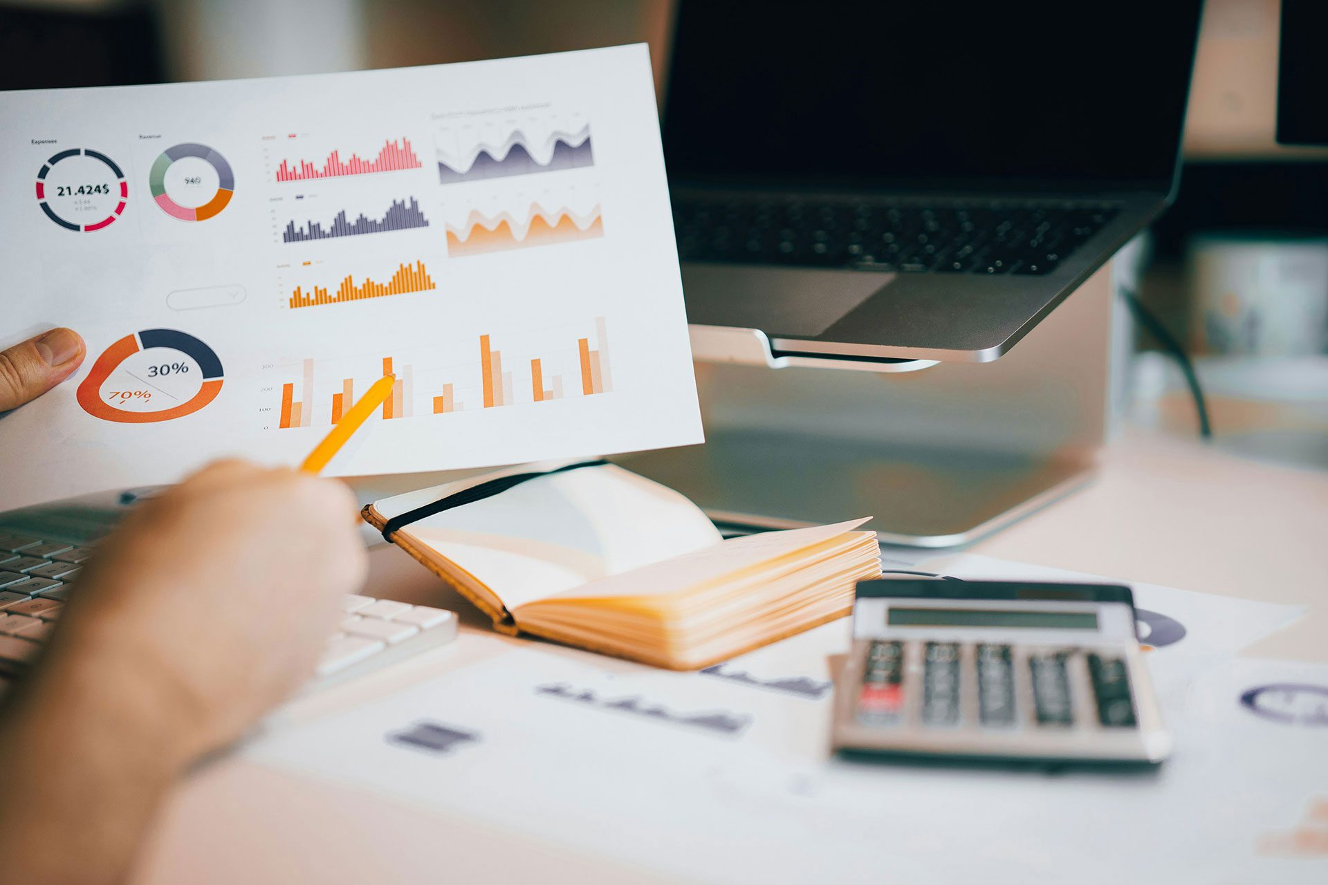 Business professional reviewing performance charts and growth metrics on a report, illustrating how SMEs can evaluate and build valuable digital assets such as brands, intellectual property, systems, and communities for long-term growth.